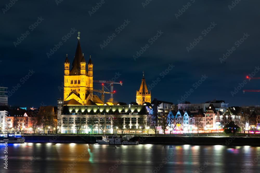 Fototapeta premium Cologne. Germany. 08.10.24. Night view of the River Rhine and the Great Saint Martin Church in Cologne (Koln), Germany.