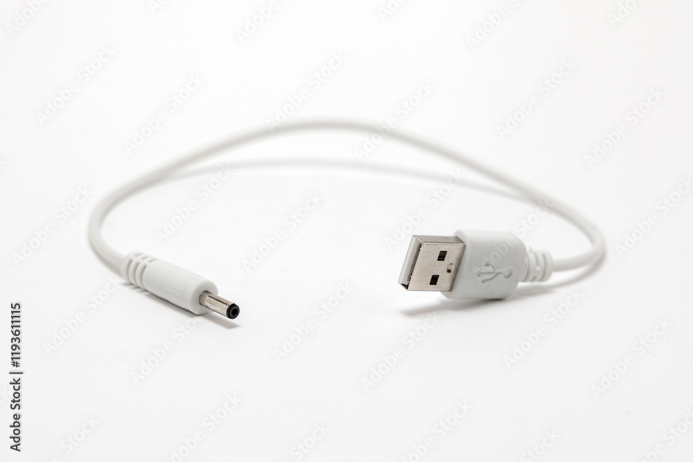 Fototapeta premium Short white cable with USB-A on one side and other device charging connector at the end