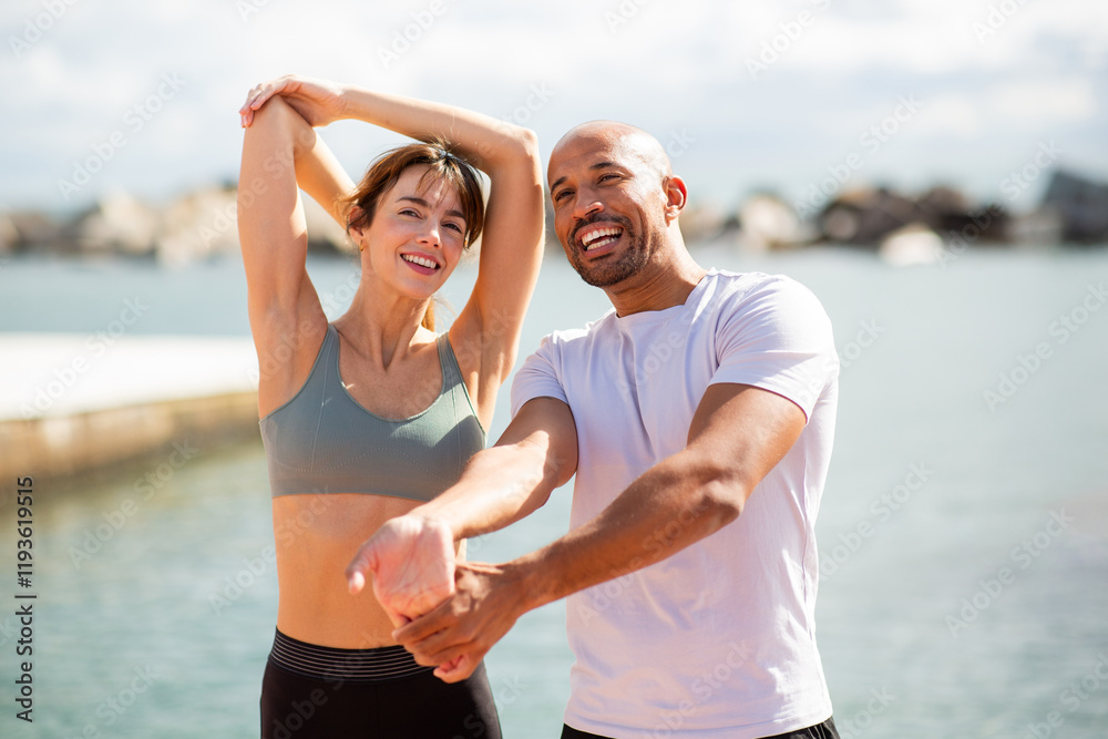 Couple Stretching outdoors Couple Stretching outdoors