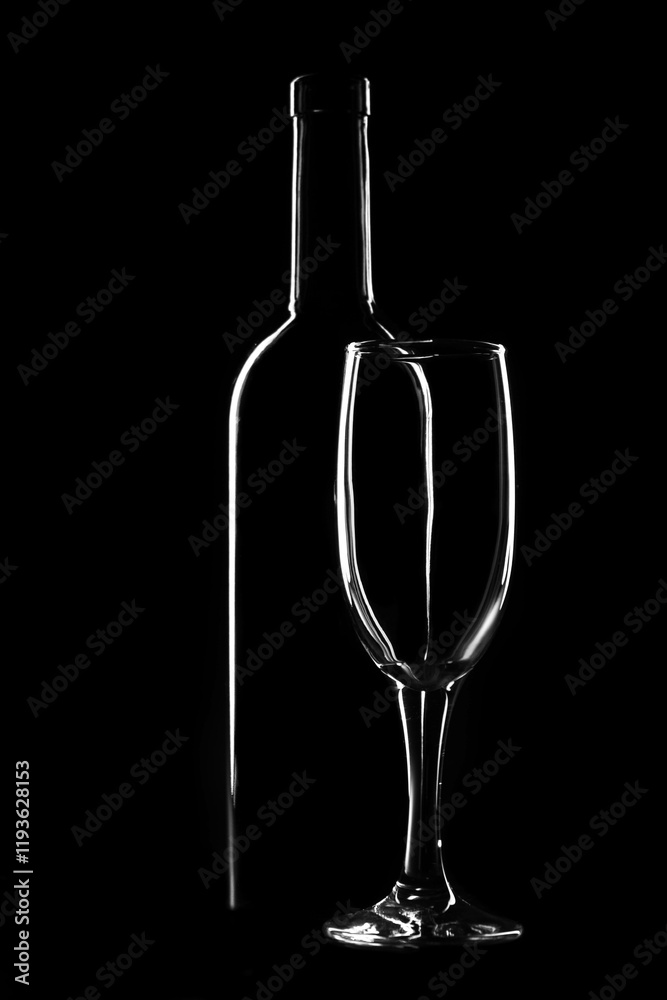 Fototapeta premium Bottle and glass on a dark background, light contours