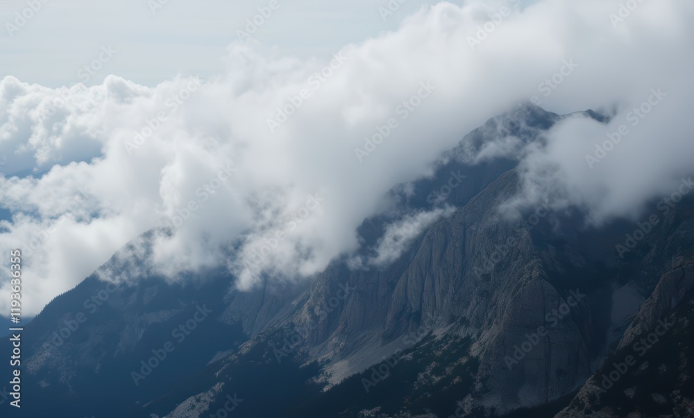 Misty mountains with dramatic cloud cover Misty mountains with dramatic cloud cover