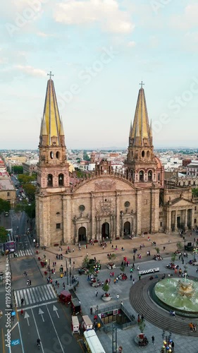 Aerial view of the facade of the Guadalajara cathedral at sunset with tourists visiting the square. Jalisco, Mexico