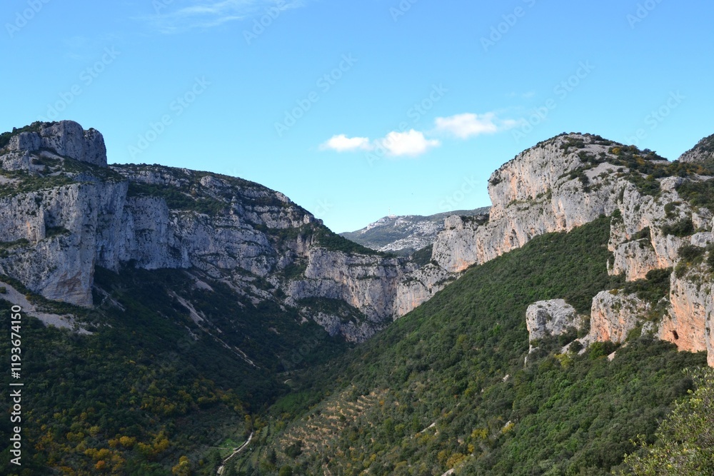 Scenic mountain landscape with lush green valleys and cliffs Scenic mountain landscape with lush green valleys and cliffs