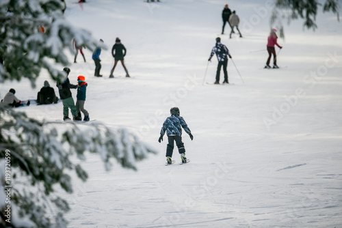 Obraz na plátně Alpine downhill ski slope in forest part of the track