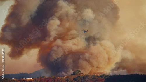 A sequence captures a massive fire in Malibu, Los Angeles, in January 7, 8, 9, 2025, as helicopters bravely fight fierce flames amid thick, dramatic smoke rising into the sky