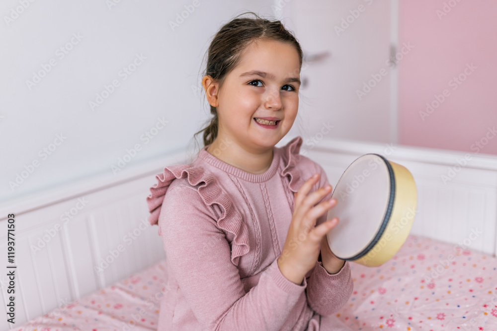 Girl playing percussion instrument at home. Girl playing percussion instrument at home.