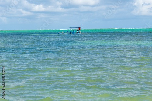 boat on the beach  tropical beach in northeastern Brazil in the state of Alagoas, city of Maceio, Ponta Verde beach photo