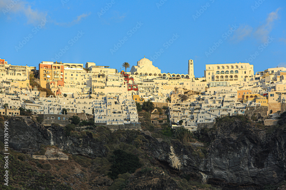 Naklejka premium Thira, Fira, Santorini, Greece. Aerial view of Santorini, Greek cathedral, white washed buildings and the Caldera