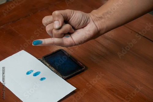 Finger man dipped in purple ink marks after the general election. presidential election day. Pemilu indonesia, Pilkada,  The finger dipped in purple ink photo