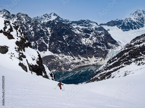 Svalbard, Norway. Solo skier having a powder run.