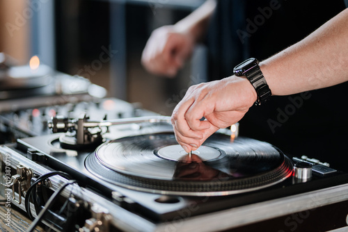 DJ mixing vinyl records on a turntable, creating an energetic vibe for a live music event