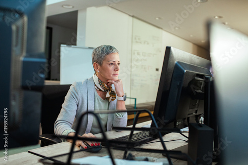 Focused businesswoman working on office computer