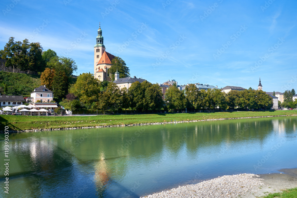 Fototapeta premium The Pfarrkirche and the Salzach River Salzburg Austria. The medieval Pfarrkirche Parish Church on a hill above the Salzach River in Salzburg, Austria.