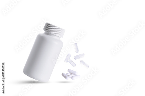 White pills bottle and falling treatment medical
pills isolated on white background.