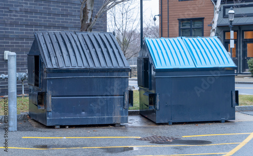 large green commercial dumpster for trash and recycling