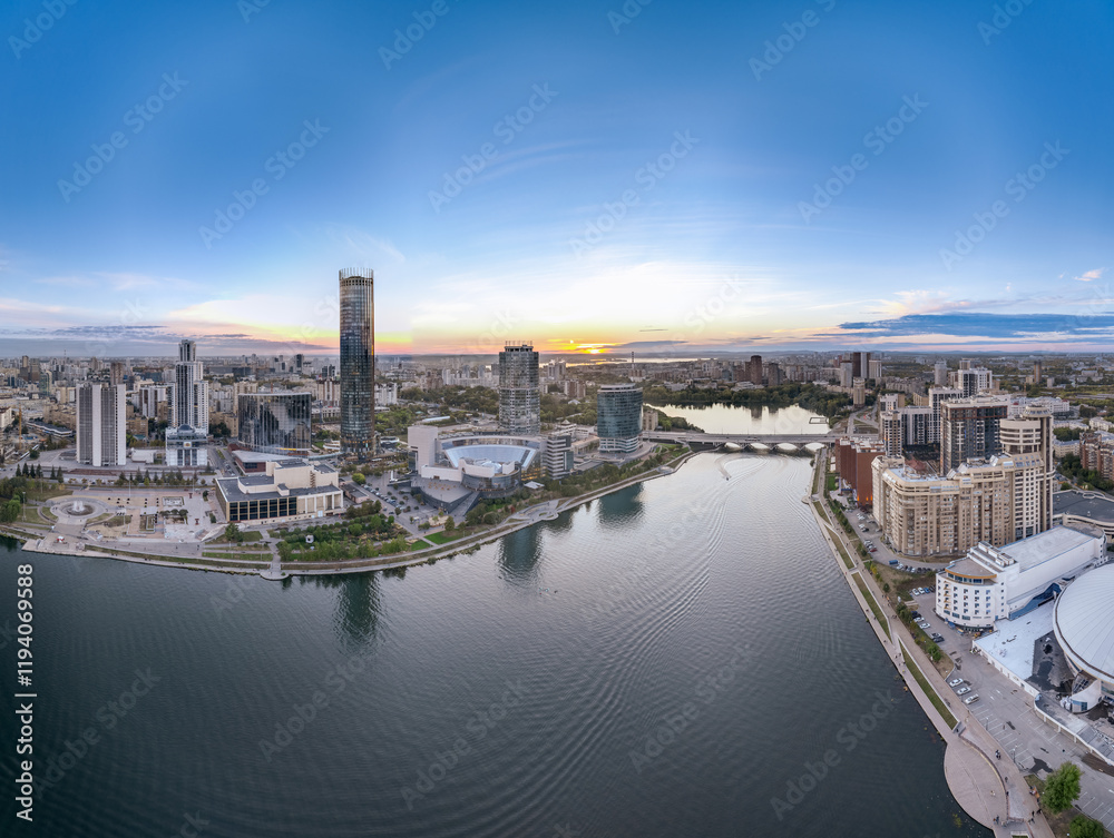 Yekaterinburg city and pond aerial panoramic view at summer or early autumn sunset. Night city in the early autumn or summer. Yekaterinburg city and pond aerial panoramic view at summer or early autumn sunset. Night city in the early autumn or summer.
