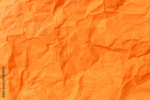 Top view and full frame of wrinkled or crumpled orange paper texture used as crumpled paper background texture in decorative art work.