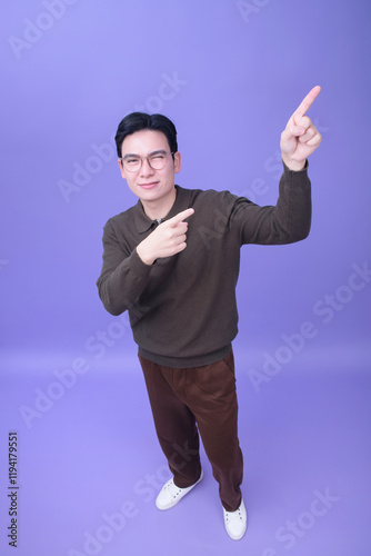 Photo of young Asian man on purple backgroundPhoto of young Asian man on purple background photo