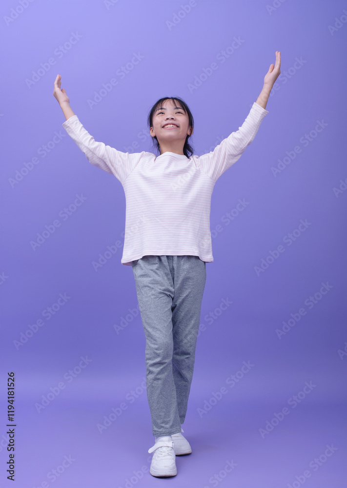 Photo of Asian little girl on purple background Photo of Asian little girl on purple background