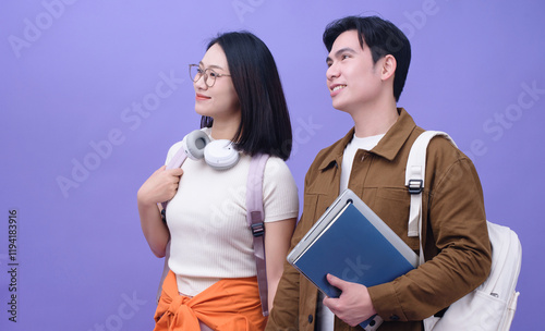 Two young Asian student on purple background