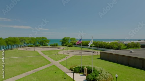 Wallpaper Mural Aerial: Drone Panning Shot Of Flags Of Usa And Chicago Waving On Poles By Wind Over Green Landscape During Sunny Day Torontodigital.ca