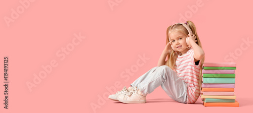 Cute little girl in headpho...