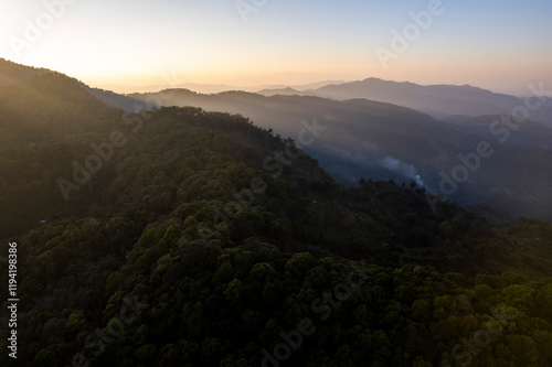 Fototapeta Naklejka Na Ścianę i Meble -  Landscape of Morning Mist with Mountain Layer. mountain ridge and clouds in rural jungle bush forest