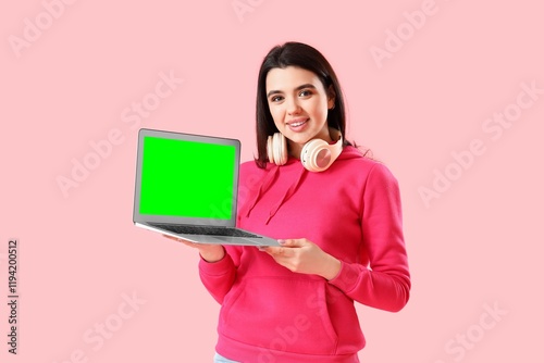 Young woman holding laptop ...
