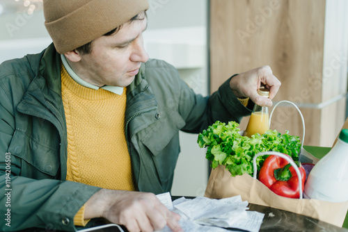 Mindful man scanning multiple receipts, comparing store prices, and maintaining healthy grocery routine, reflecting commitment to financial well-being. photo