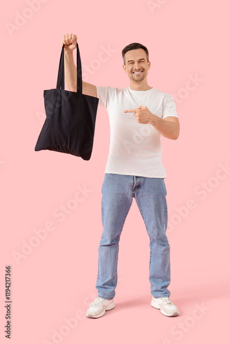Man with eco bag on pink ba...
