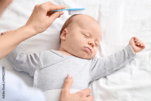 Mother brushing her little ...