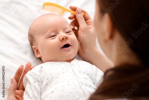 Mother combing her little b...
