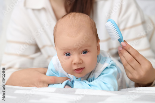 Woman brushing her little b...