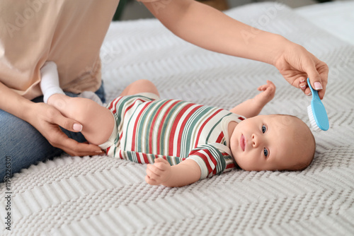 Woman brushing her little b...