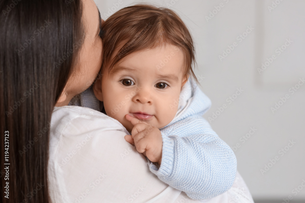 Young mother holding her baby at home, closeup Young mother holding her baby at home, closeup