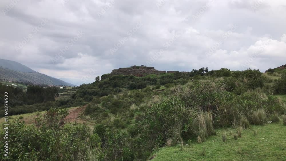Lush vegetation surrounds the ancient ruins of kenko, a significant inca archaeological site near Lush vegetation surrounds the ancient ruins of kenko, a significant inca archaeological site near