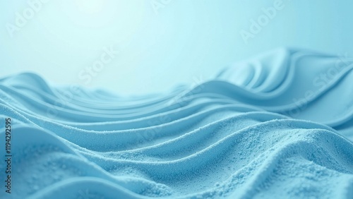 Vibrant light blue sand with undulating waves creates an ethereal pattern against a soft backdrop; the upper portion fades into gentle blur