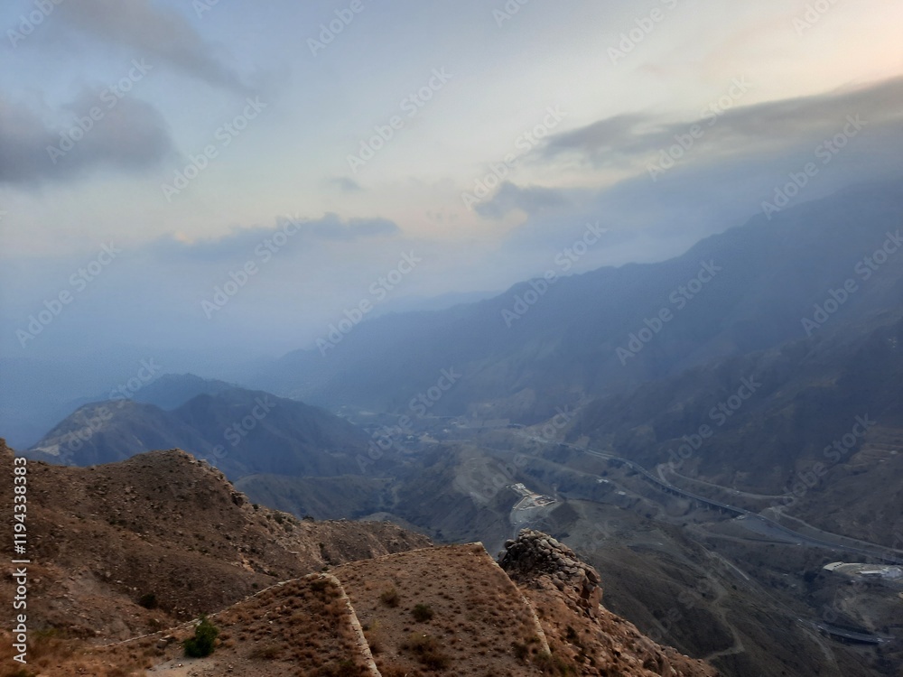 Obraz premium Stunning sunset panorama of the hills surrounding Abha city as seen from High City, Abha.