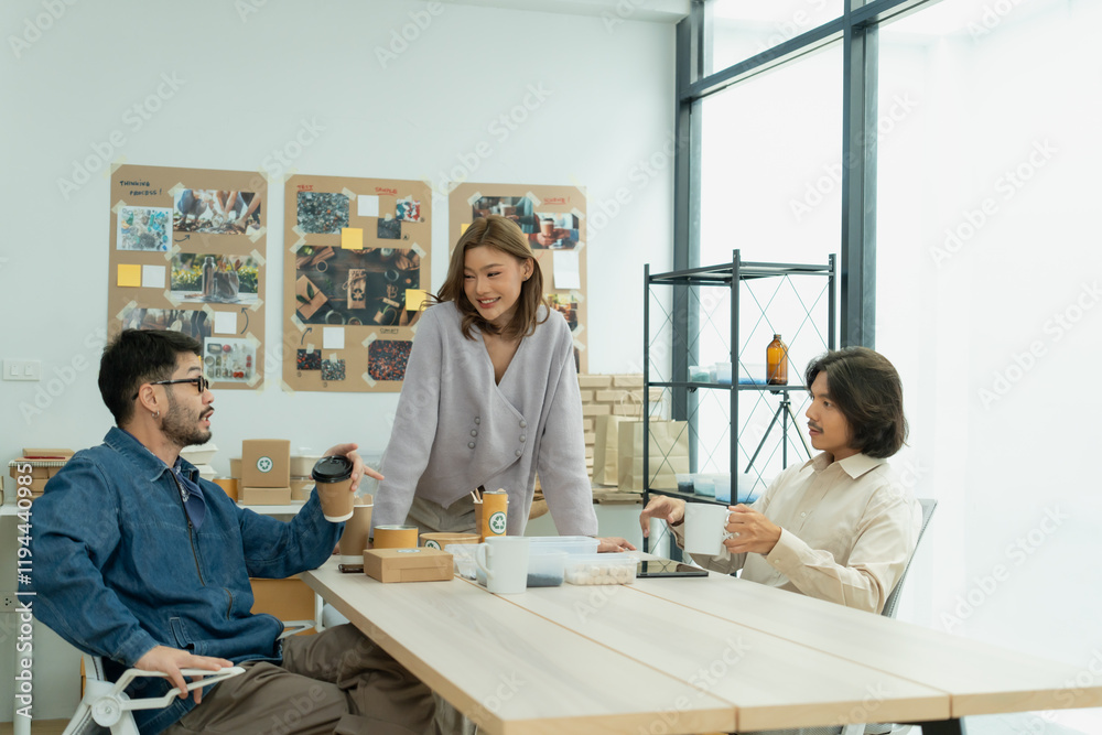 Diverse team having a casual discussion about eco-friendly product packaging in creative office space Diverse team having a casual discussion about eco-friendly product packaging in creative office space