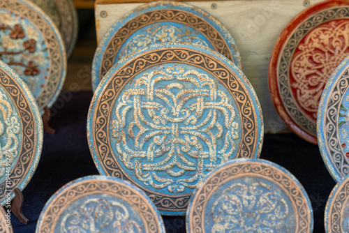 A collection of blue and white plates with designs on them. The plates are arranged in a row and are of various sizes