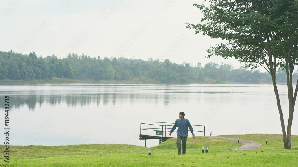 travel and people activity concept with asian man relax and see sunrise with cloudy and sky with mountain and lake on morning travel and people activity concept with asian man relax and see sunrise with cloudy and sky with mountain and lake on morning