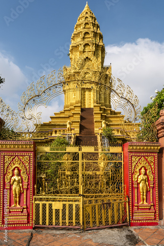 Decorative Doorway and Pagoda in Wat Ounalom a wat located on Sisowath Quay in Phnom Penh, Cambodia photo