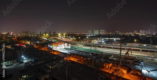 Nighttime traffic flows along Beijing Jingtong Expressway showcasing urban life and vibrant city lights photo