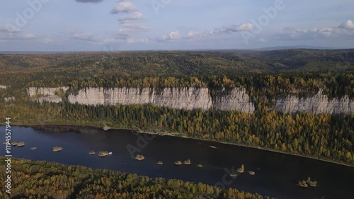 Flight over a sunny autumn forest and river
