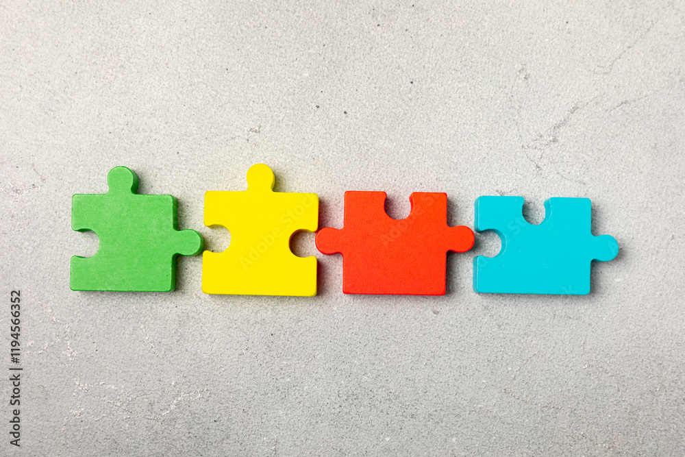 Obraz premium Autism puzzle.Autism awareness day. Colorful bright puzzles.Puzzle. 2 April world autism awareness day background. Top view. Space for text.Copy space.Design element.Care Awareness campaign for Autism