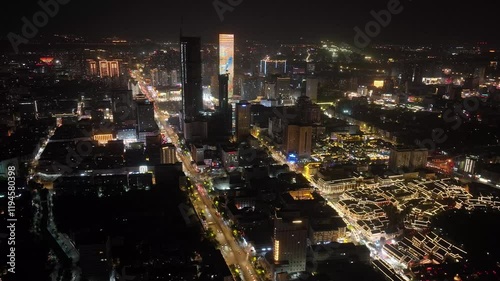 Stunning aerial view of Xuzhou city skyline at night with illuminated Suning Plaza photo