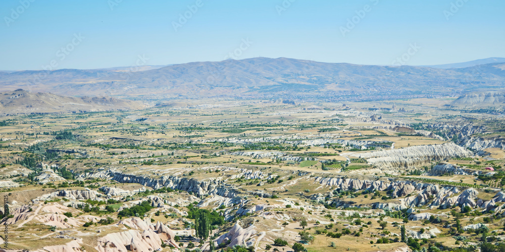 Obraz premium Uchhisar city from a height in Cappadocia, Central Anatolia region, Turkey. Tuff mountains.