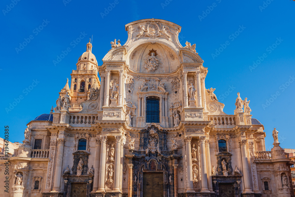 Front view of the facade in baroque-style of the Roman Catholic Cathedral of Murcia in Spain Front view of the facade in baroque-style of the Roman Catholic Cathedral of Murcia in Spain