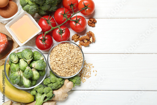 Different fresh products rich in melatonin on white wooden table, flat lay. Space for text photo