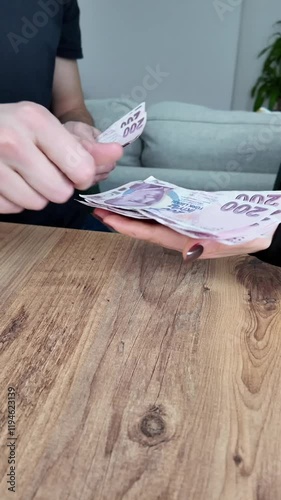 husband gives his wife the money savings for mortgage, school tuition, repair invoice. domestic economy at home. earning money. business.